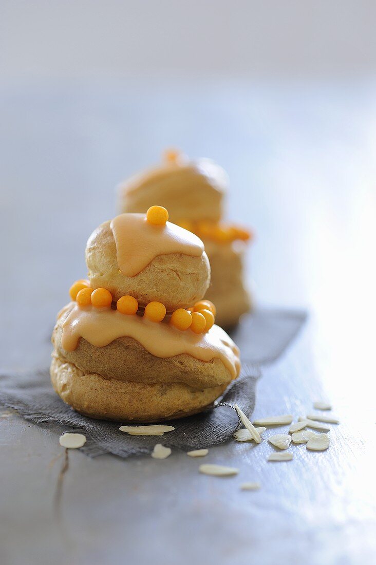 Profiteroles with honey cream, orange icing & flaked almonds