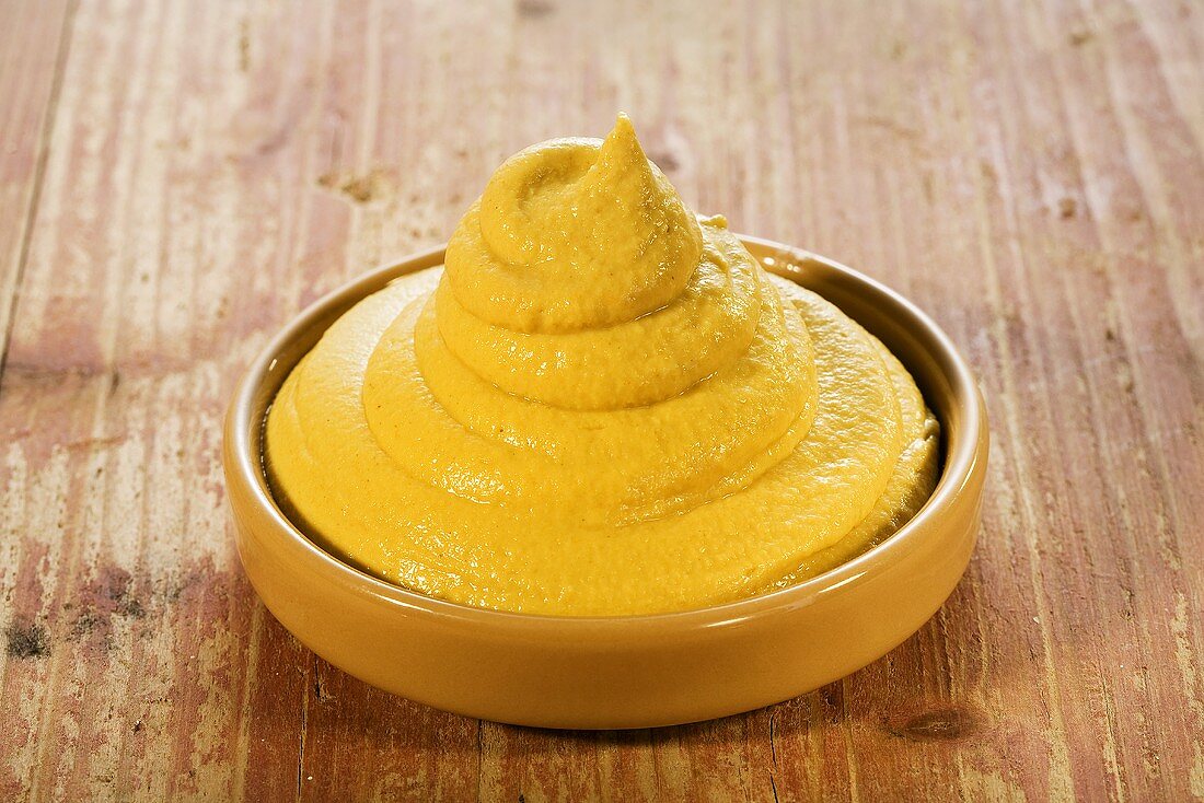 Mustard in brown dish
