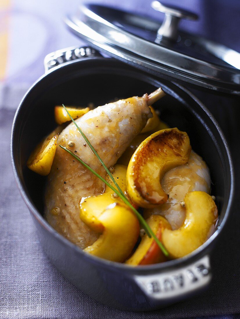 Chicken legs with apples in pot