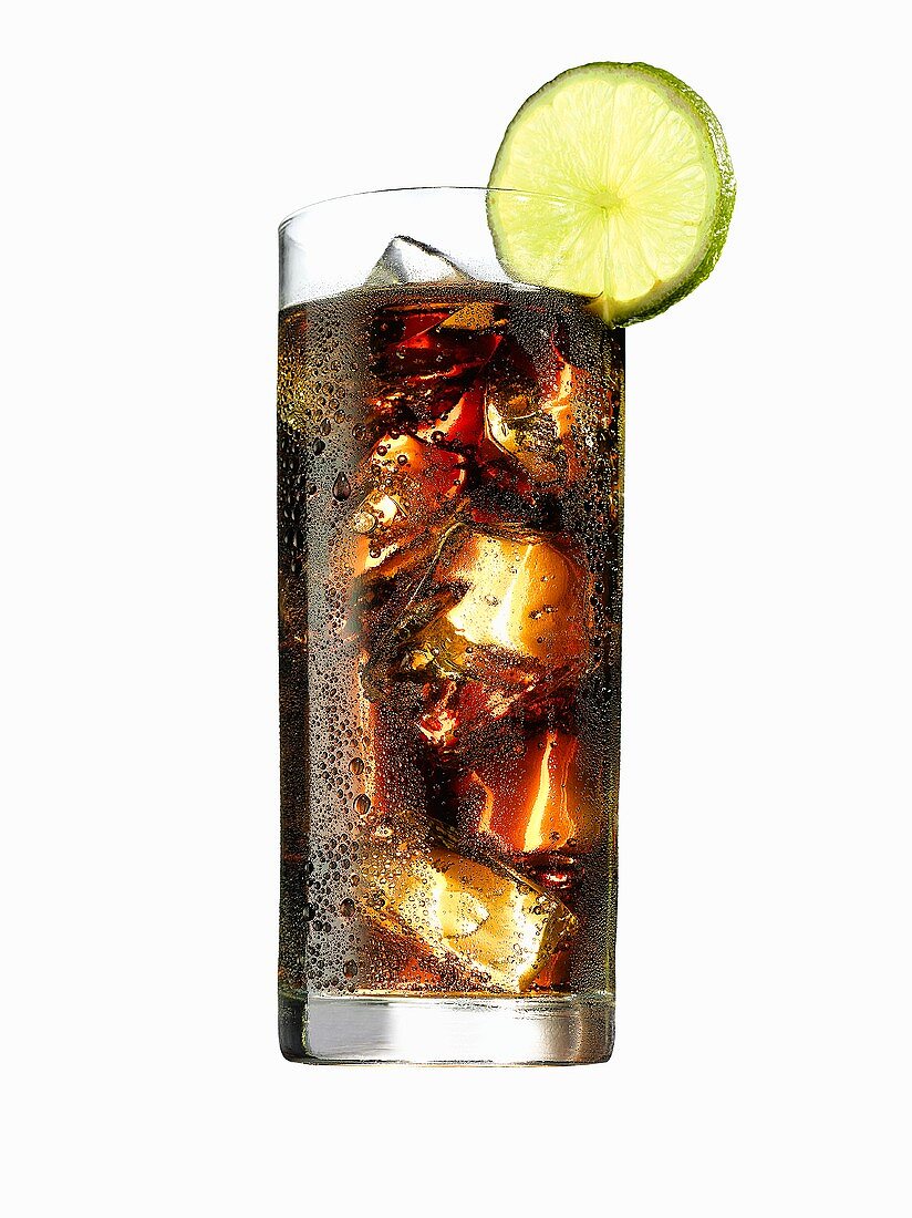 Glass of cola with ice cubes and lime (with condensation)