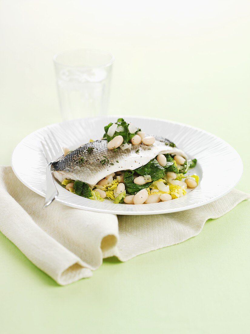 Sea bass on white beans and spinach