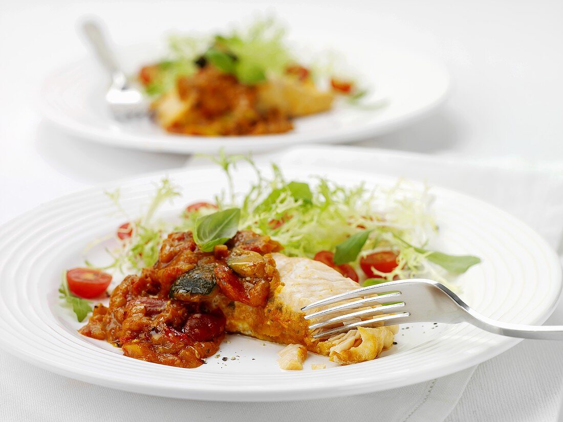 Steamed salmon with tomato sauce and salad leaves