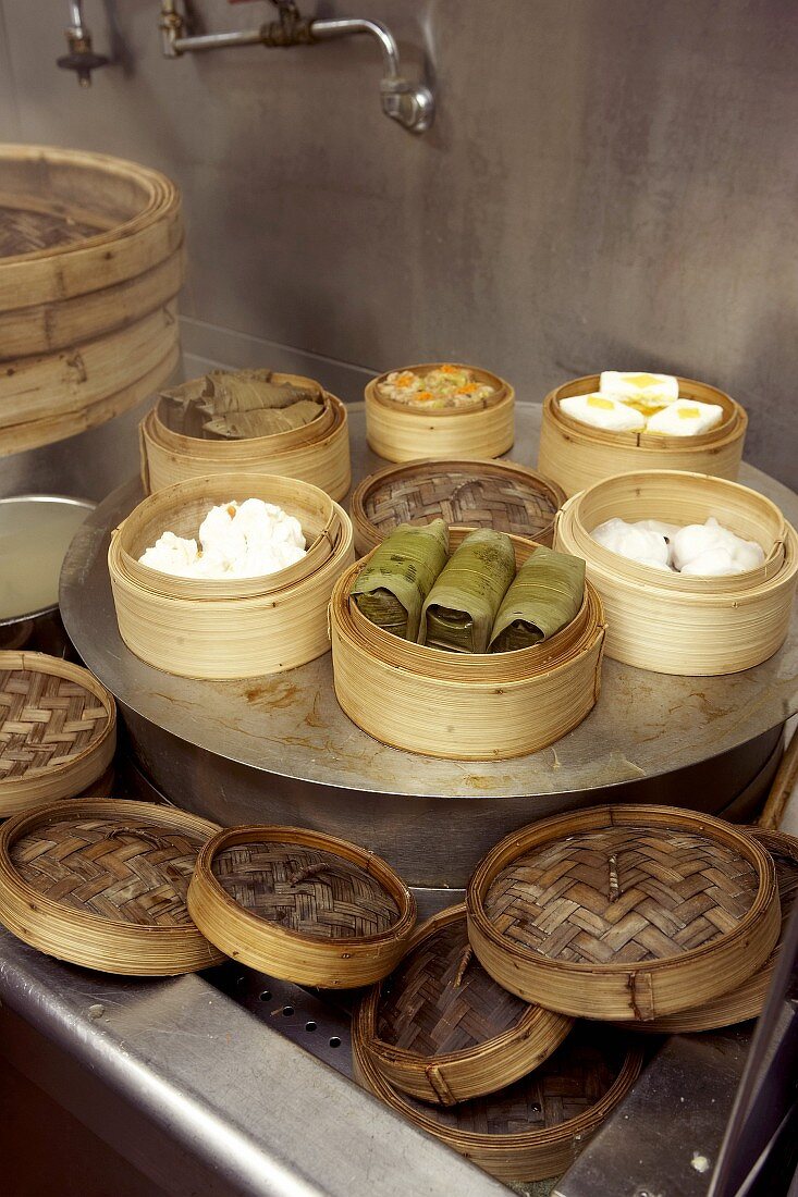 Assorted dim sum in bamboo steamers in eating house (Asia)