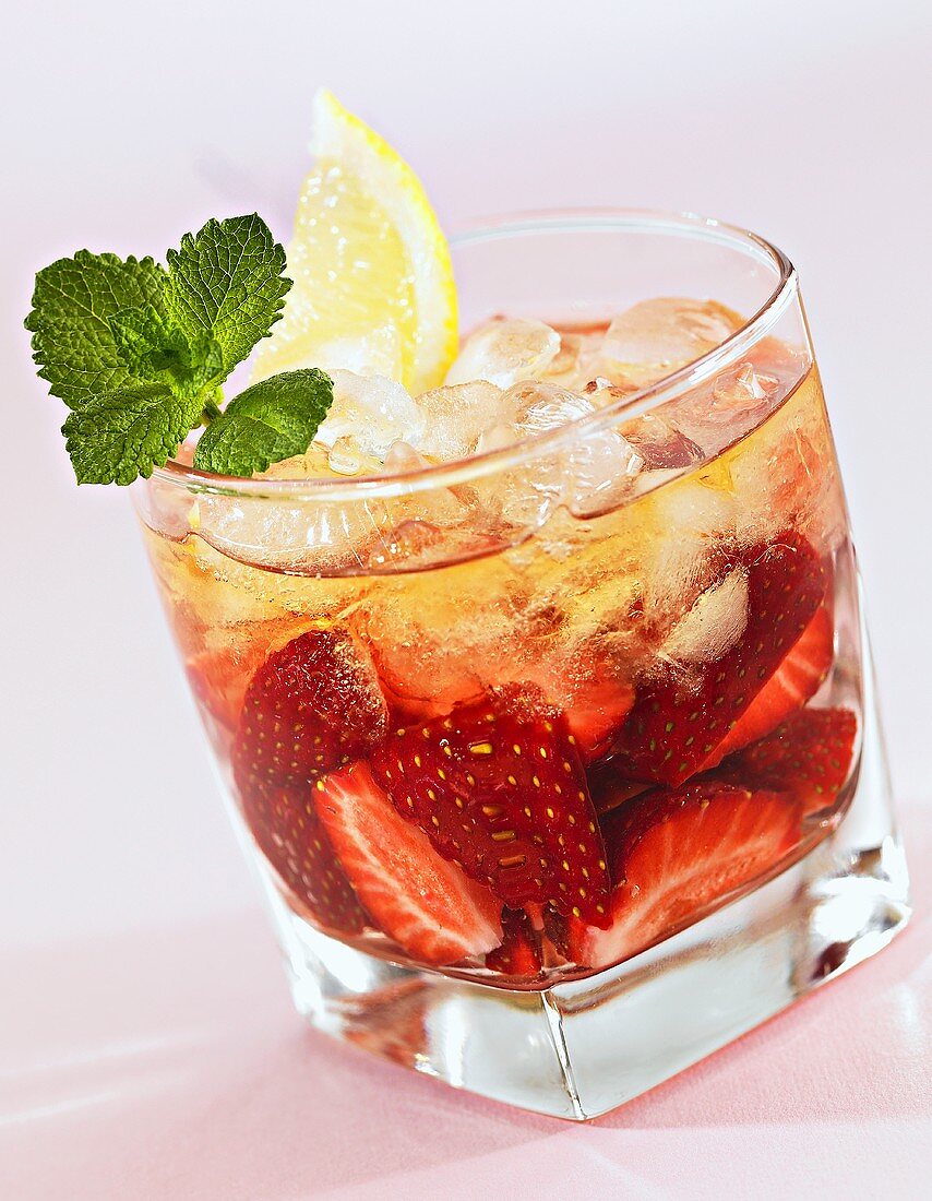 Strawberry punch with lemon juice and ice cubes
