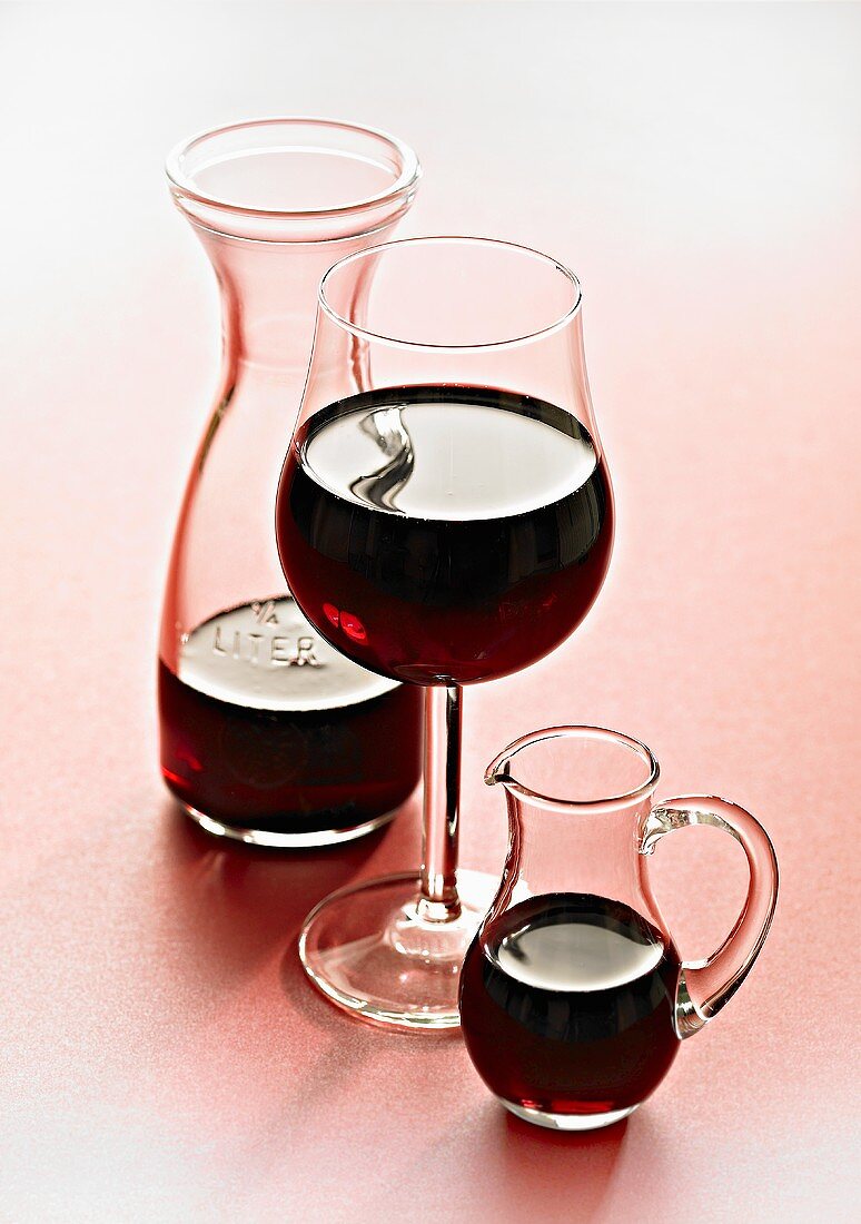 Red wine in glass and carafes