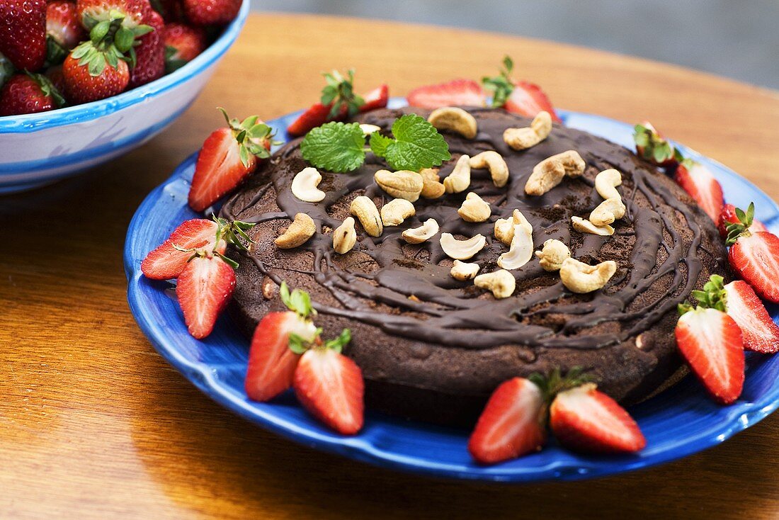 Chocolate cake with strawberries and cashew nuts