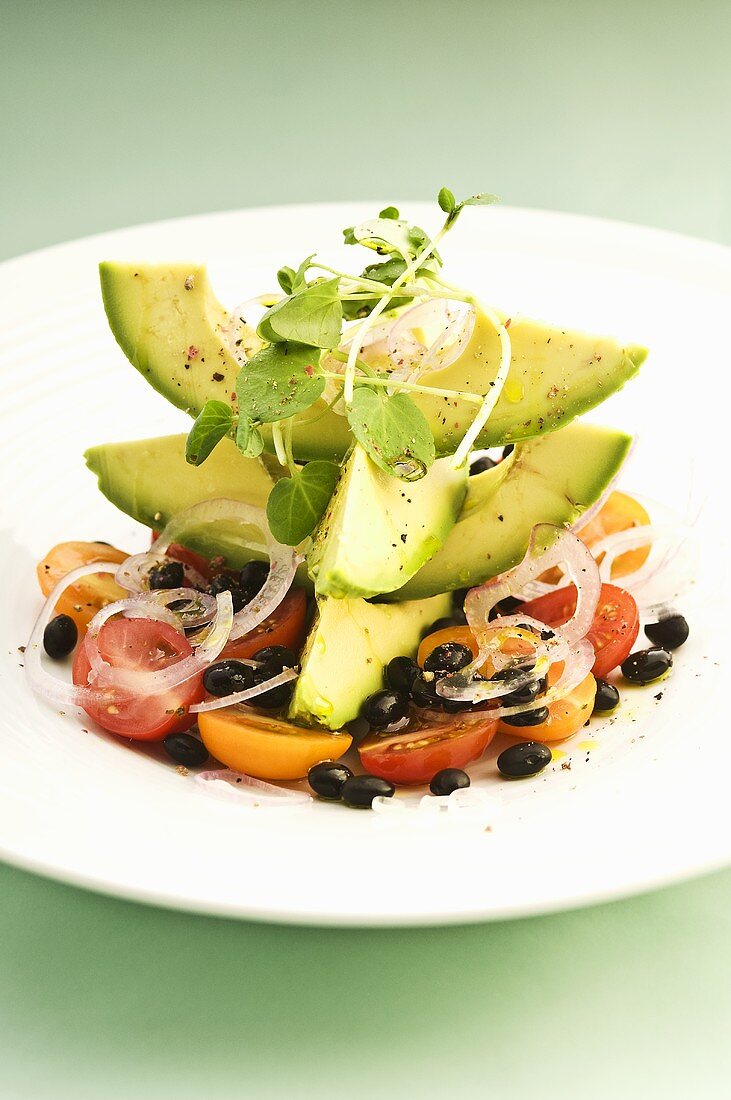 Avocado, tomato and black bean salad with watercress