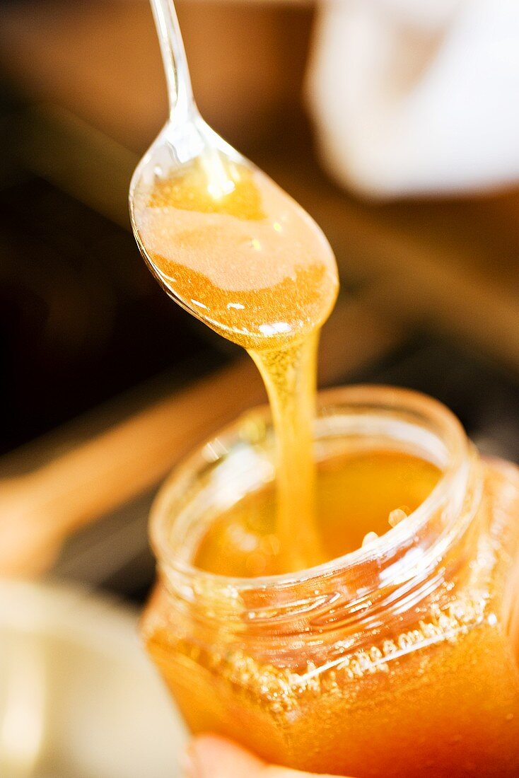 Honey on spoon and in jar