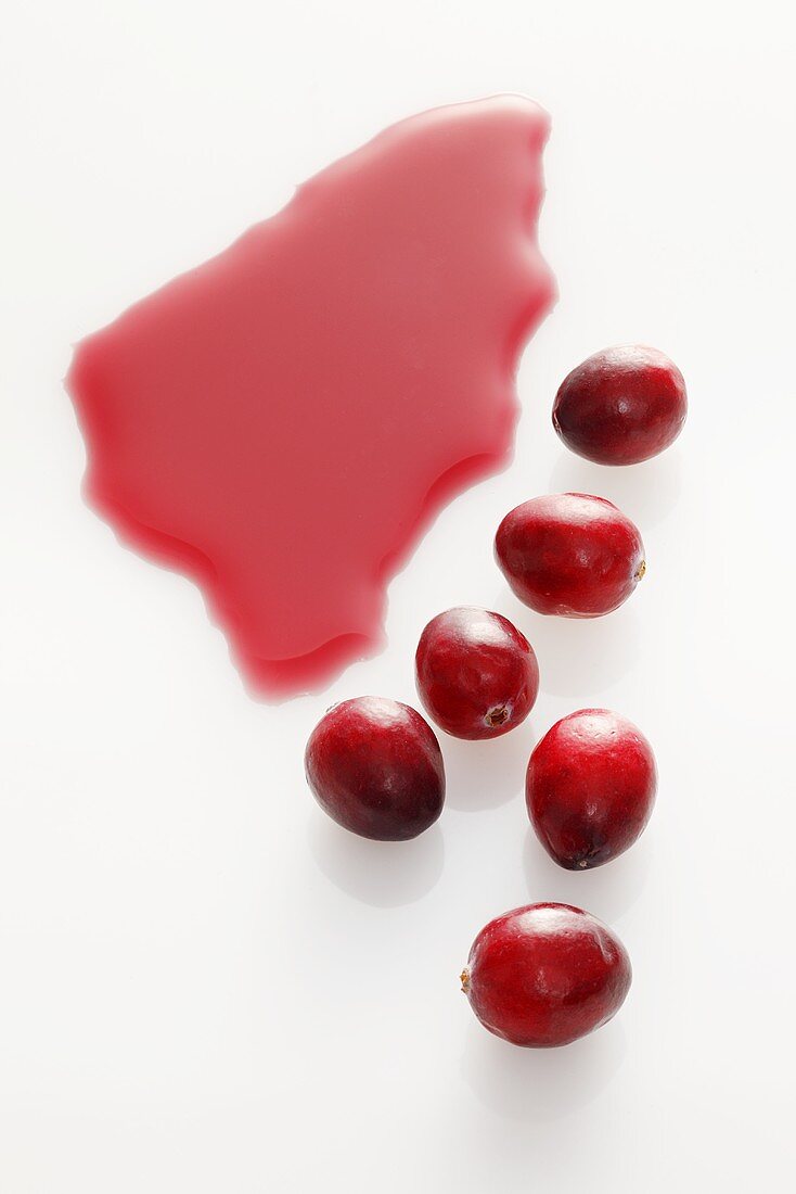 Cranberry juice and cranberries on white background