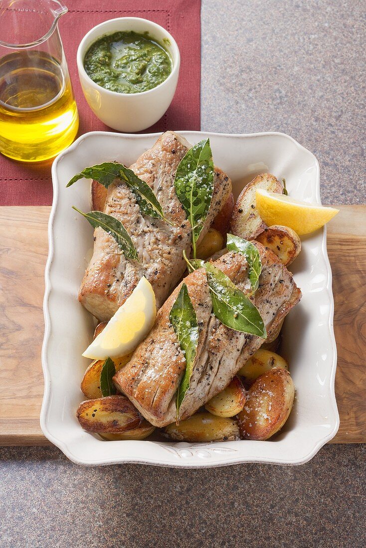 Pork fillet with salsa verde, potatoes and bay leaves