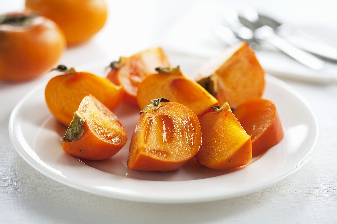 Persimmon wedges on plate