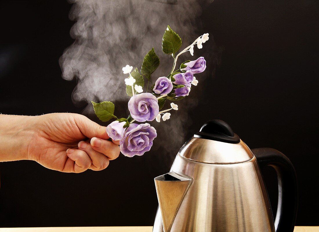 Holding spray of sugar roses over steam