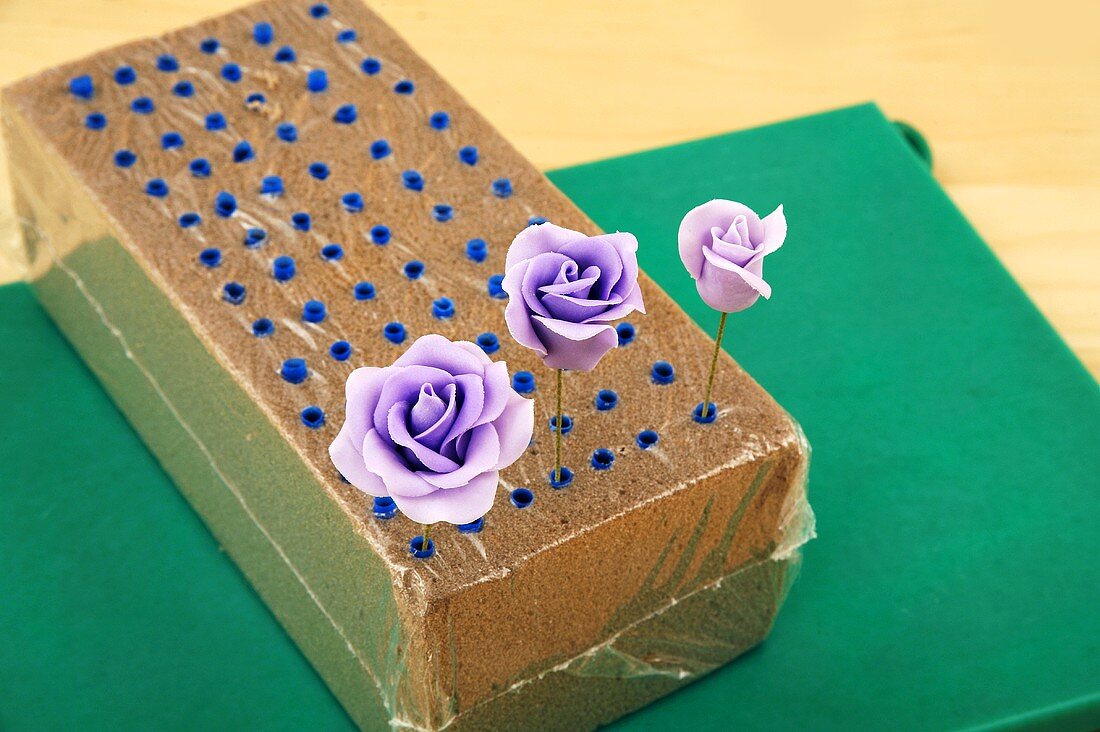 Purple sugar roses in a block of foam