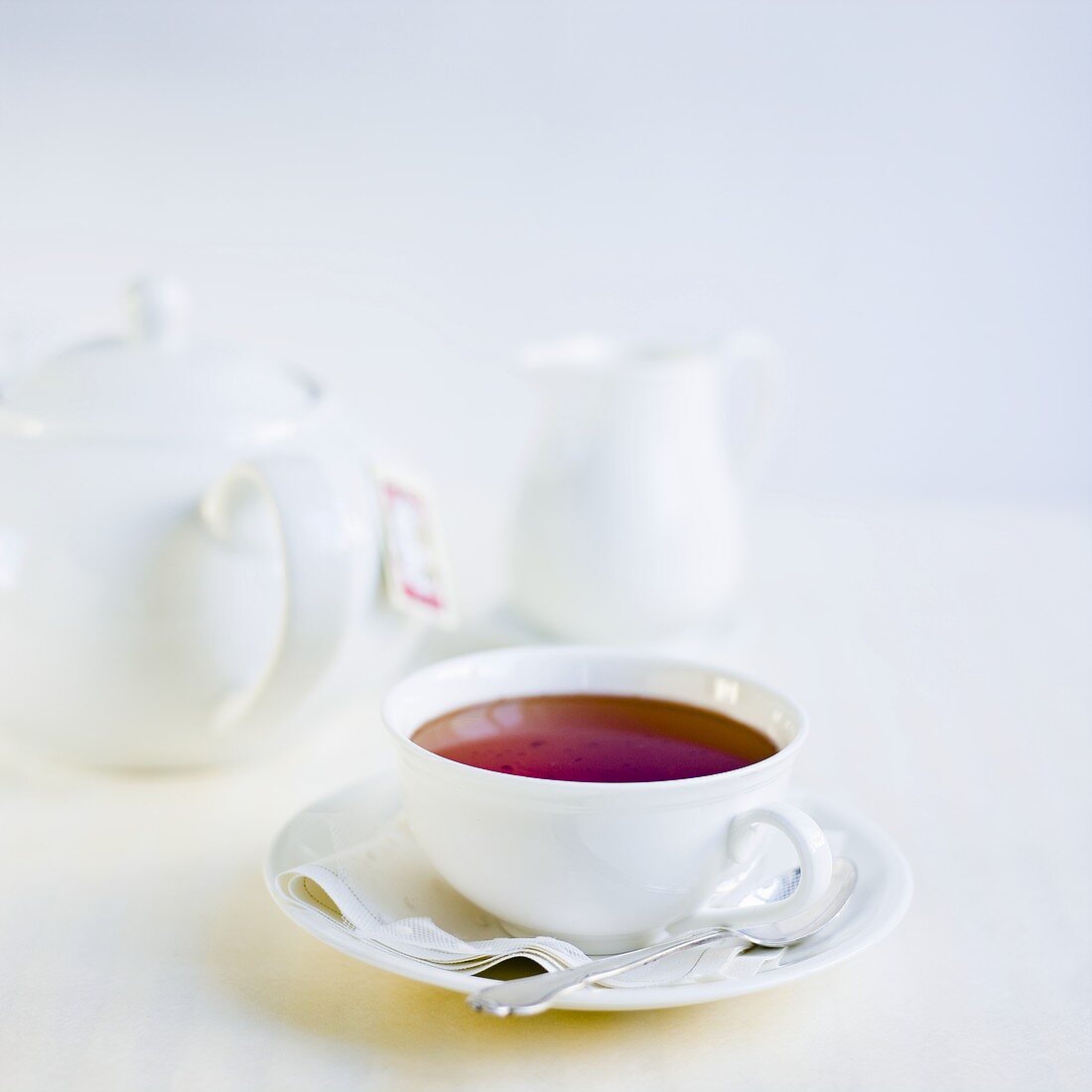 Cup of tea, teapot and cream jug