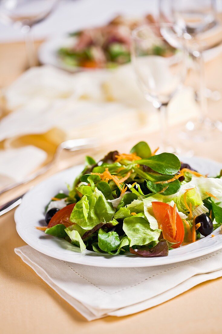 Mixed salad on laid table