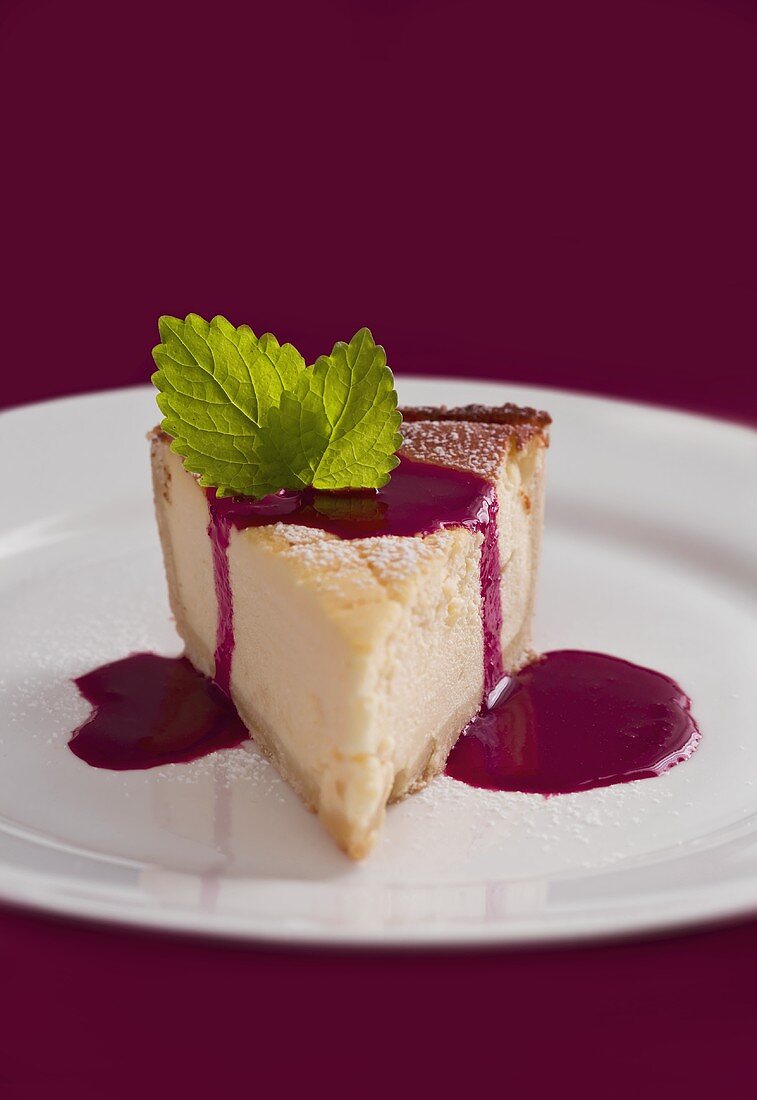 Piece of cheesecake with fruit sauce