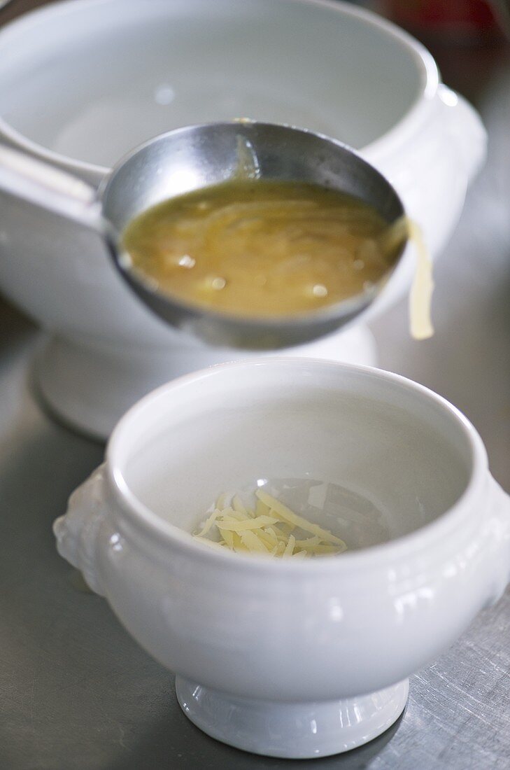 Ladling French onion soup into a bowl