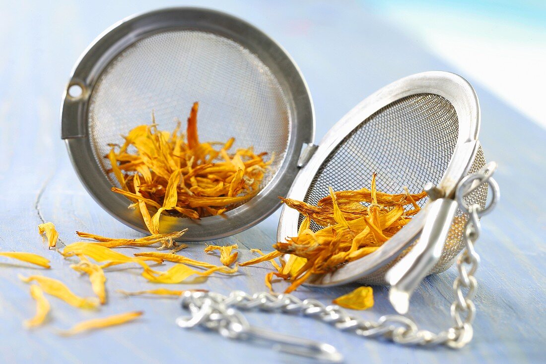 Dried marigold petals in a tea infuser