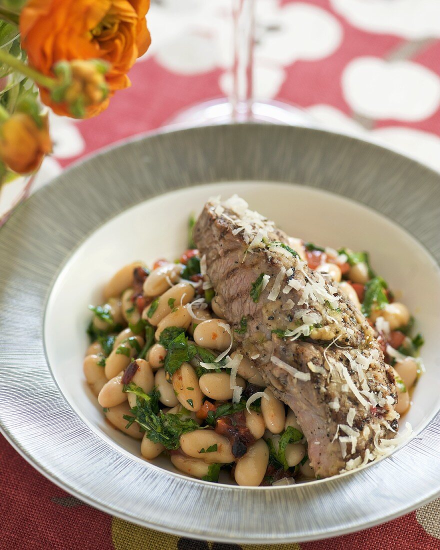 Grilled lamb steak with warm bean salad