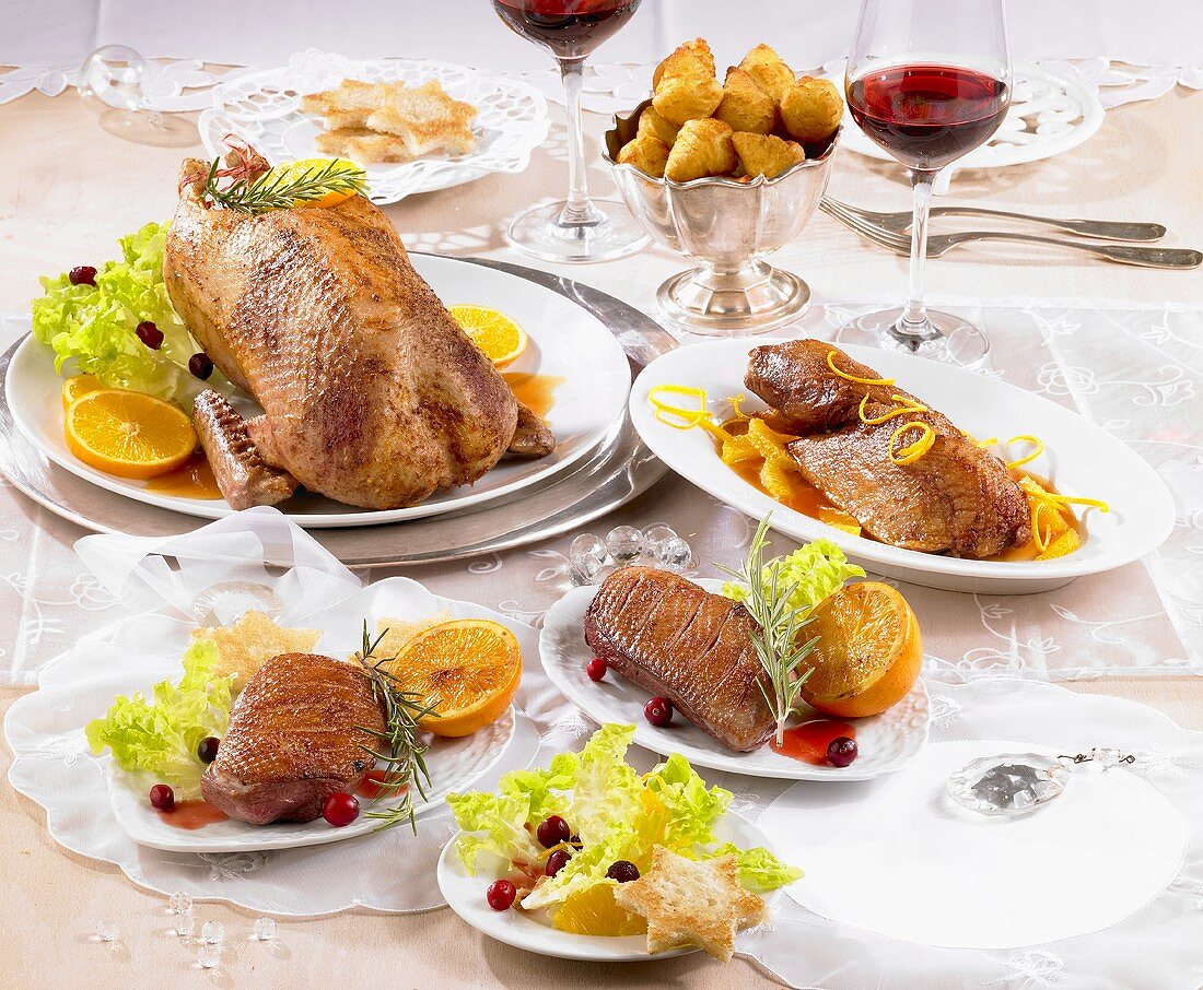 Various duck dishes on laid table