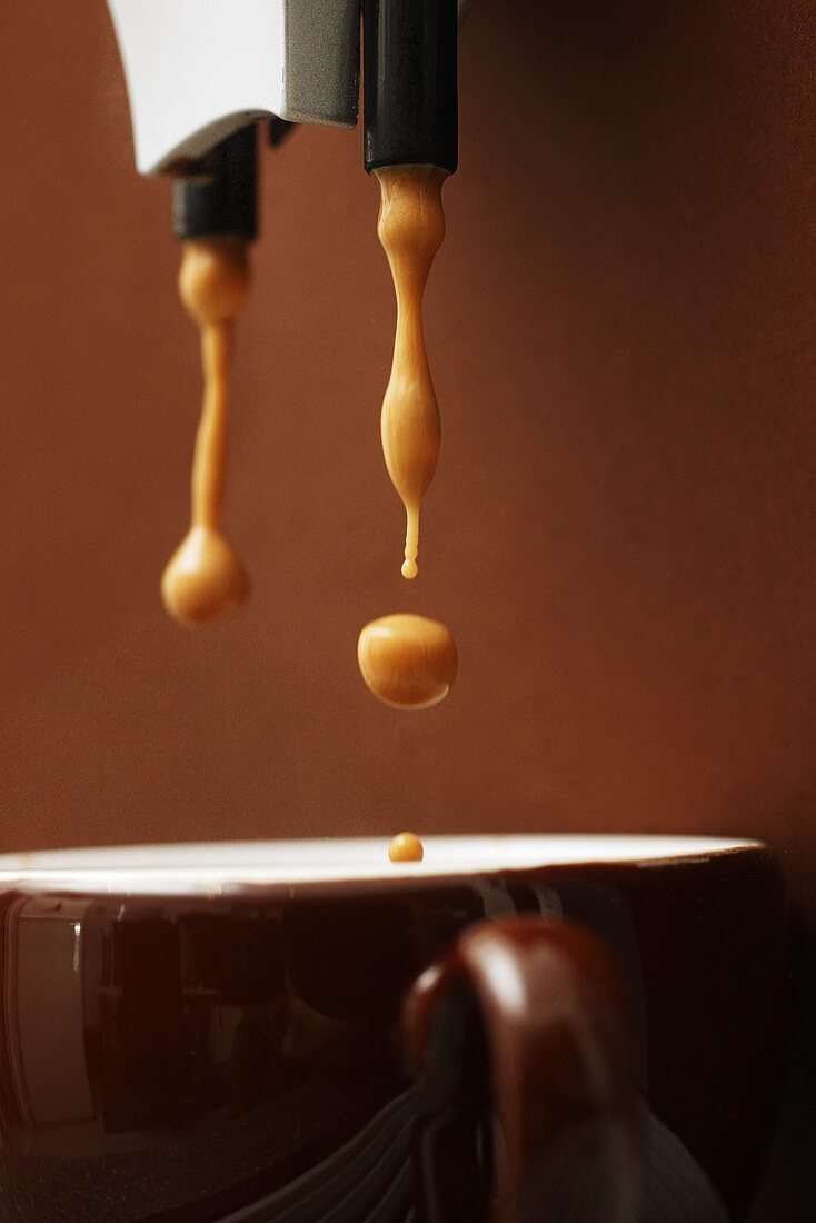 Espresso dripping into cup