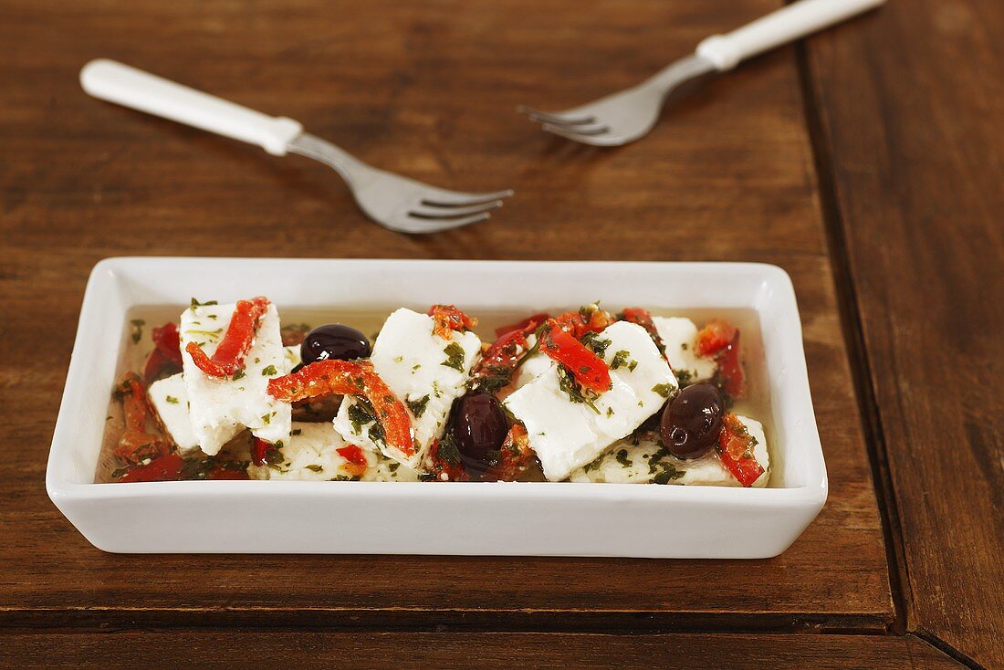 Marinated feta with olives, peppers and herbs
