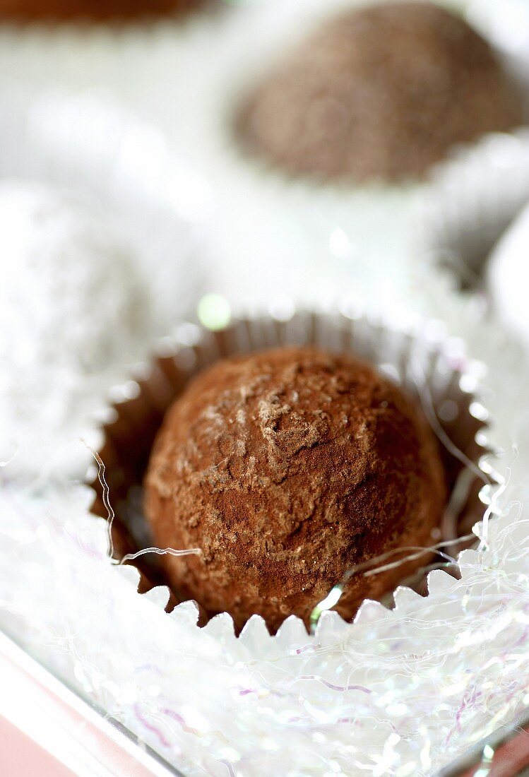 Chocolate truffles in silver foil cases (close-up)