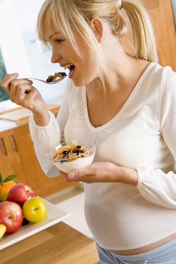 Schwangere Frau isst Cornflakes