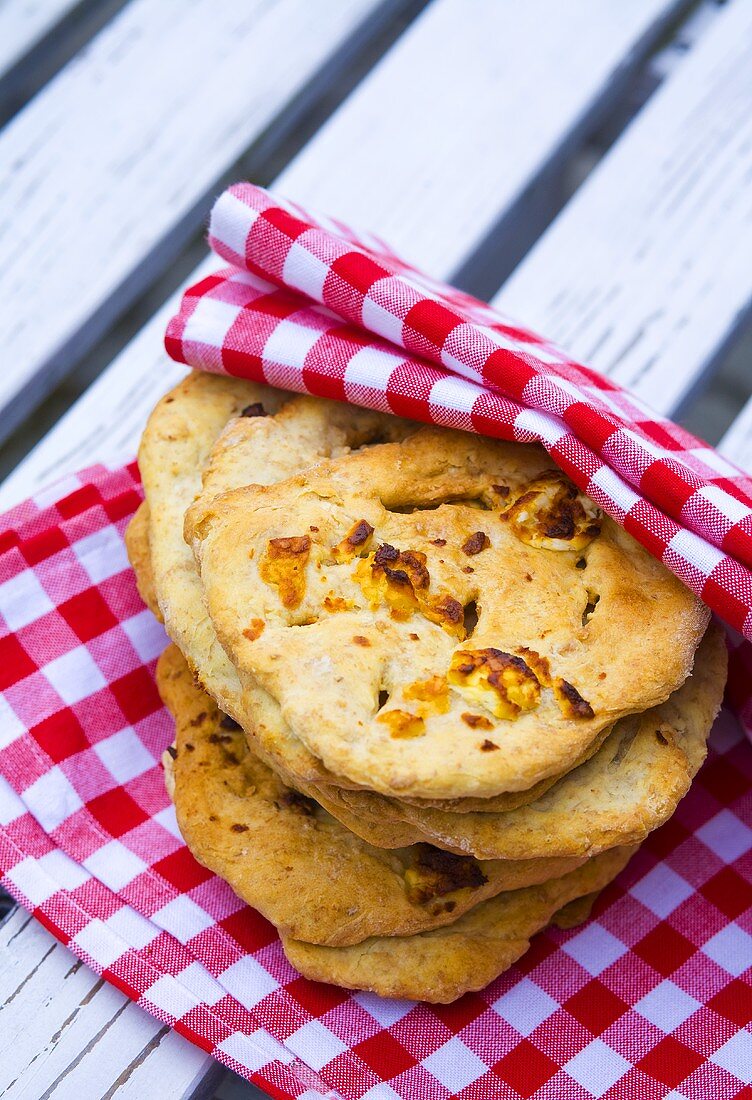 Focaccia with cheese on checked cloth