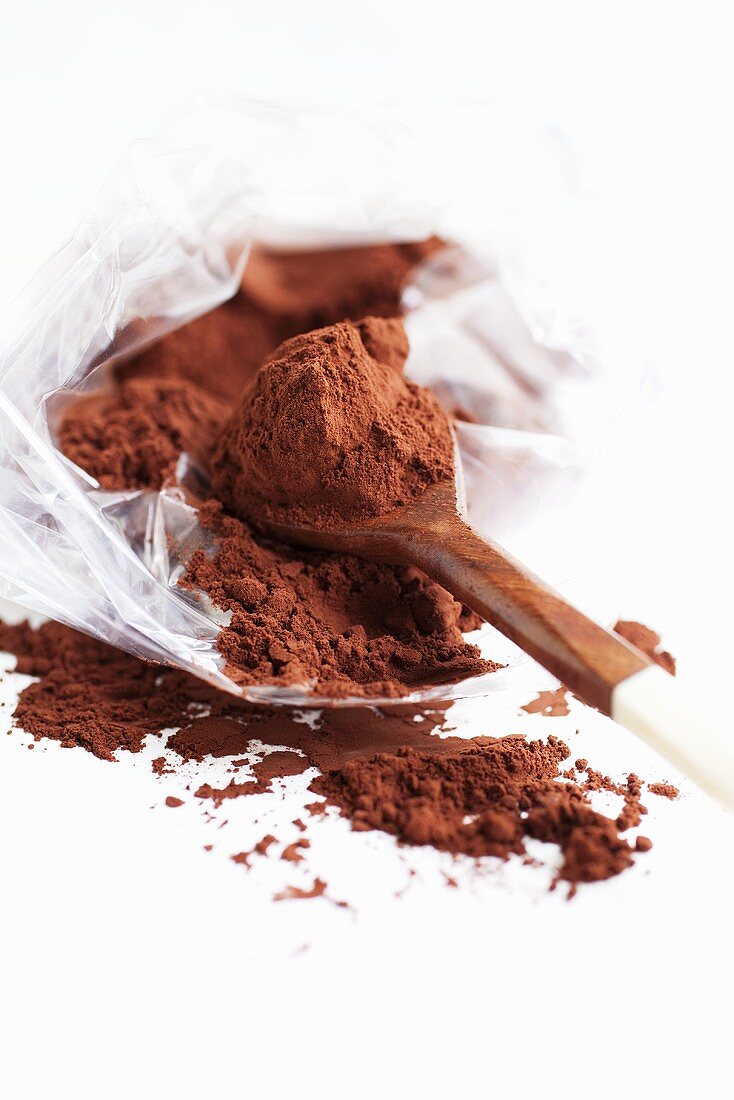 Cocoa powder in plastic bag and on spoon