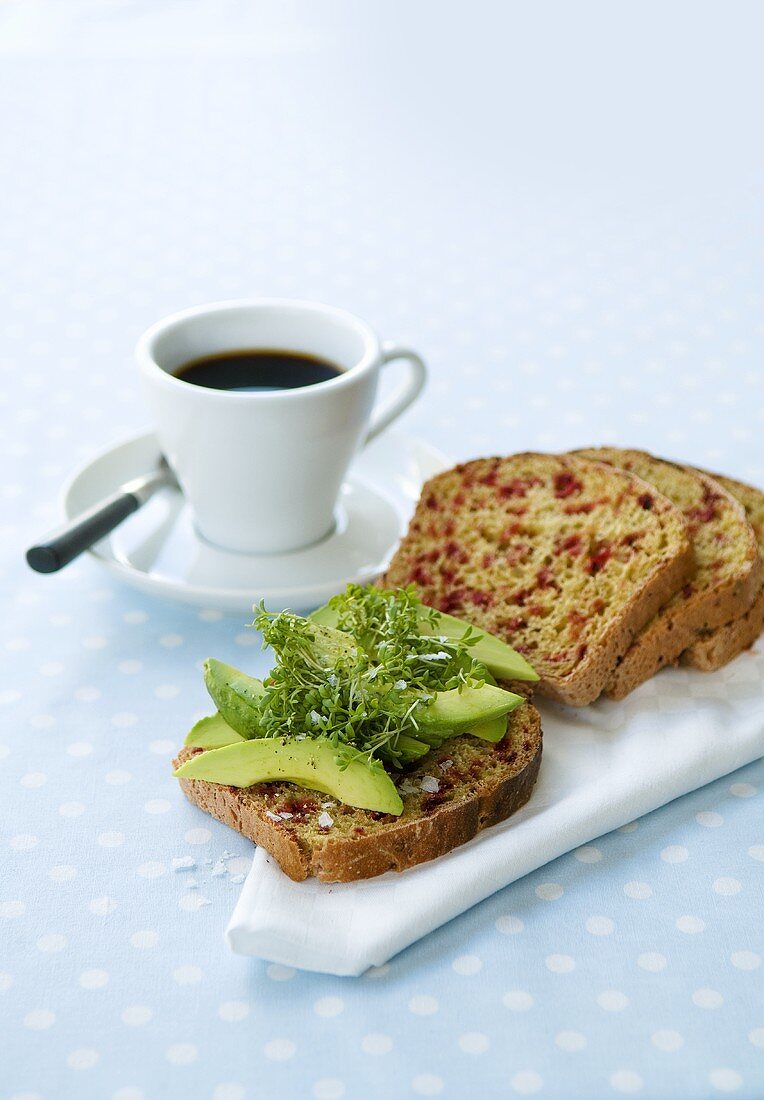 Avocado on beetroot bread, cup of coffee