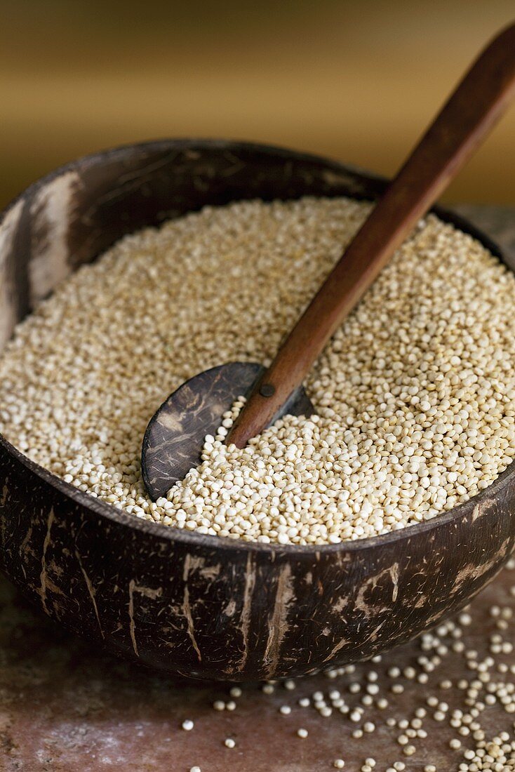 Quinoa in wooden bowl with wooden spoon