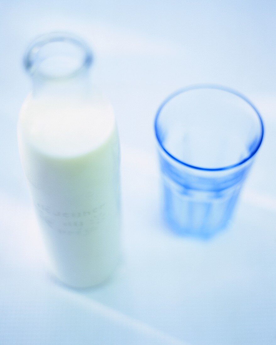 A bottle of milk and a glass
