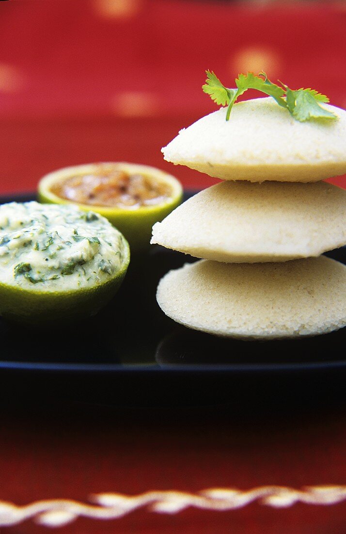 Idli (steamed Indian rice cakes) with chutneys