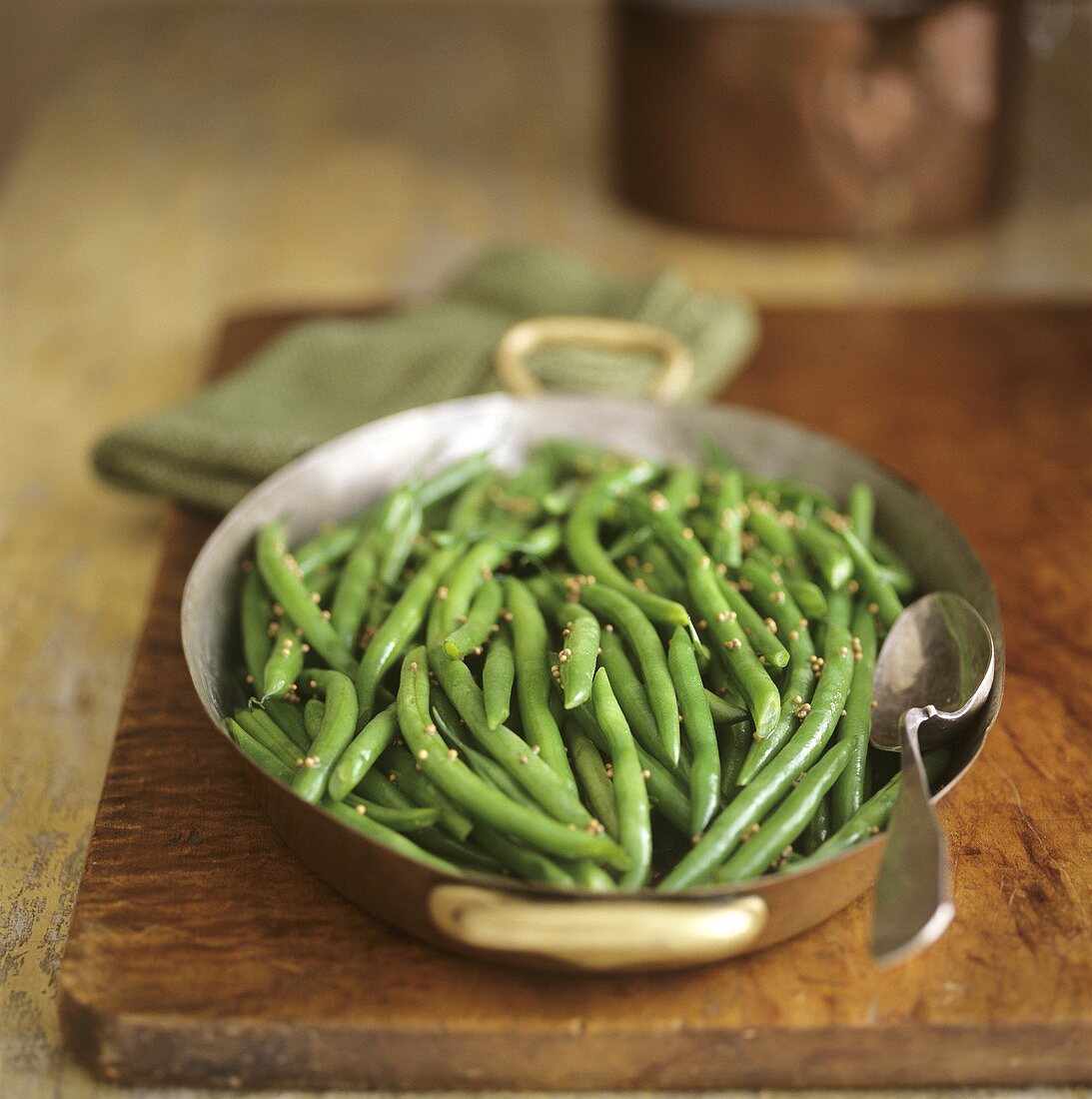 Green beans with mustard seeds in a small pan