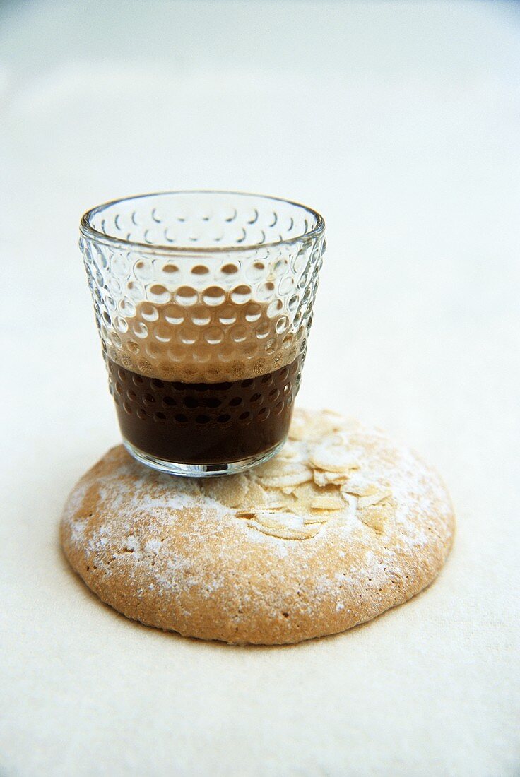 Espresso in glass on almond biscuit