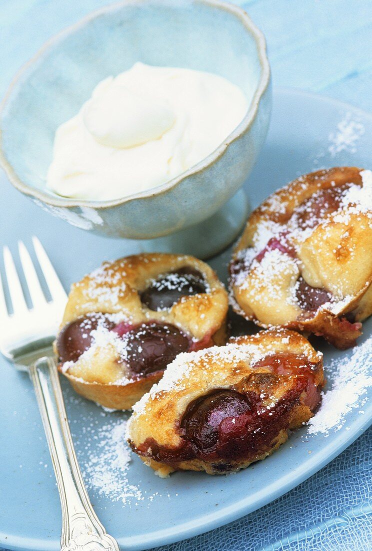 Small cherry cakes with whipped cream
