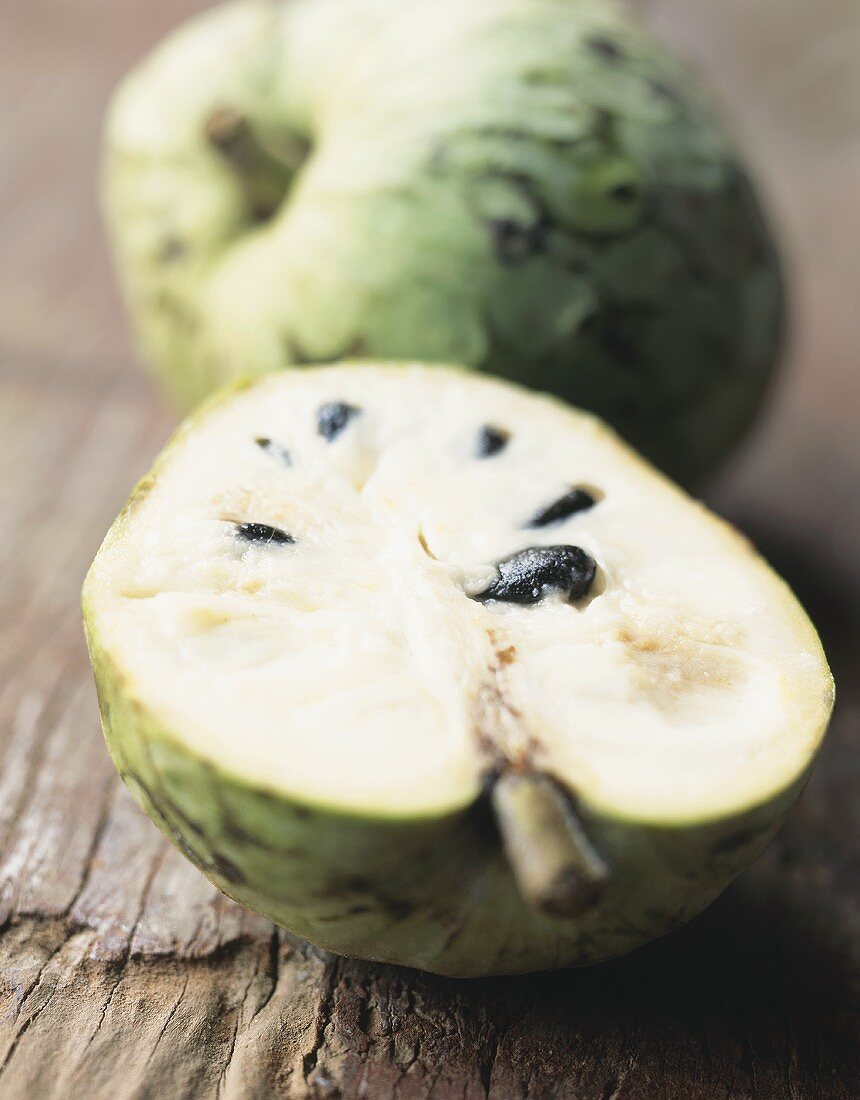 Whole and half cherimoya