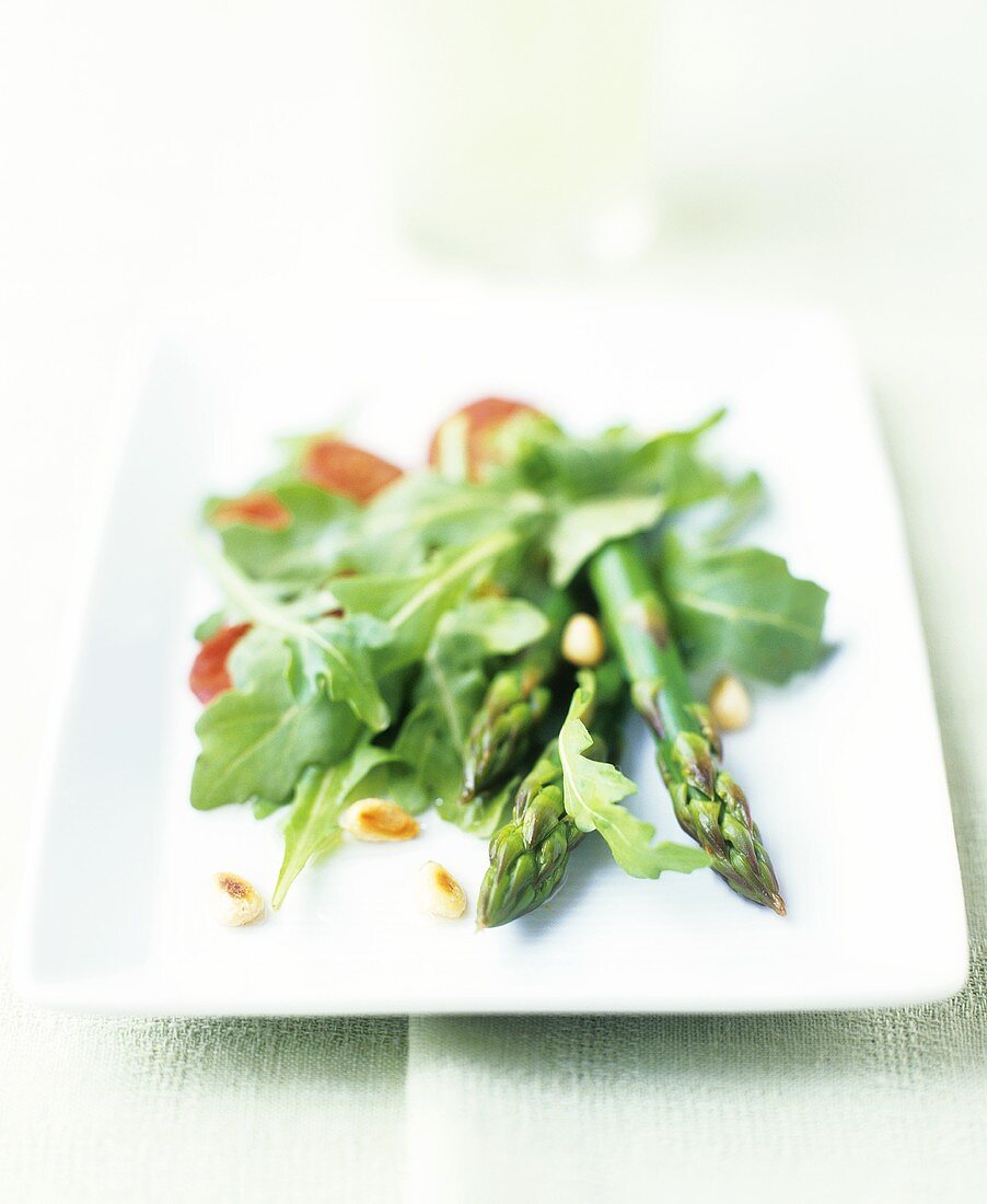 Asparagus salad with rocket, pine nuts and chorizo