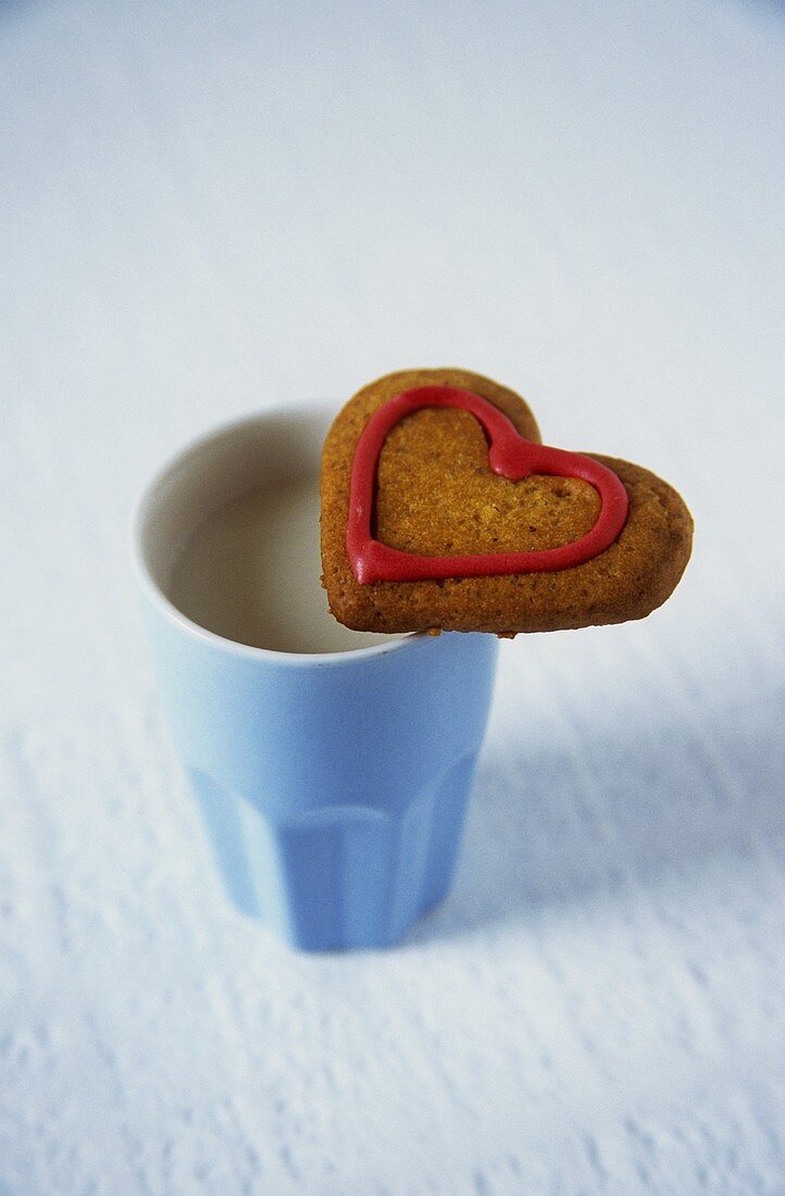 Heart-shaped biscuit with coffee