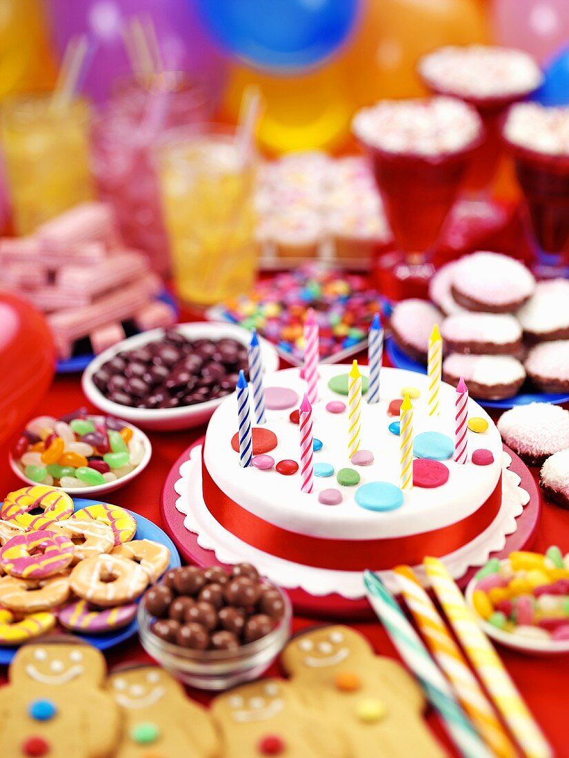 Party buffet with birthday cake, sweets, biscuits etc.