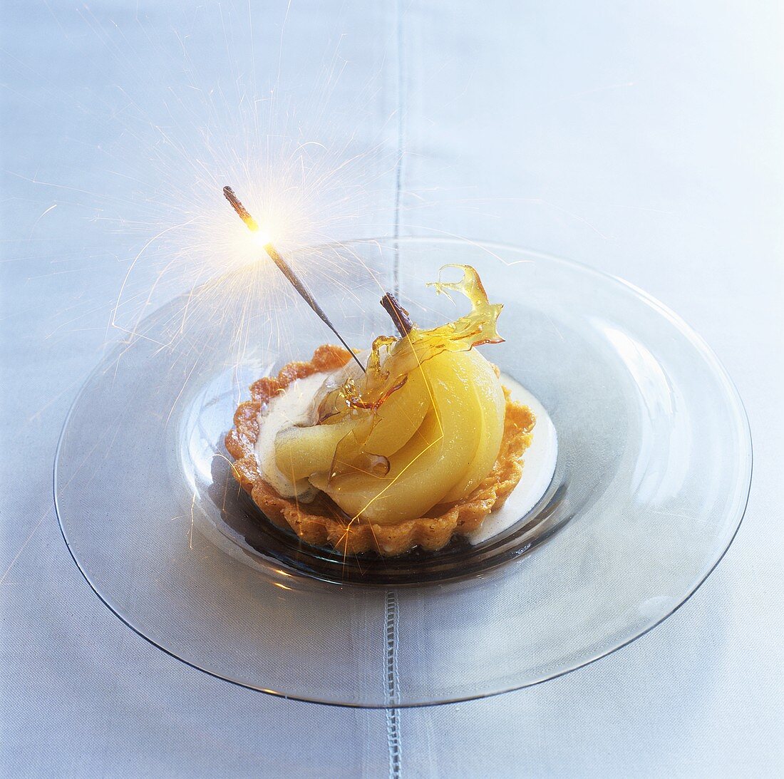 Pear and almond tartlet with spun sugar and sparkler