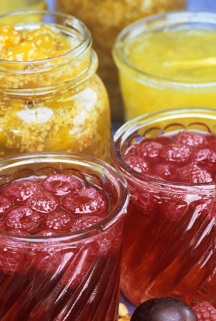 Raspberry jam and pineapple jam in jars