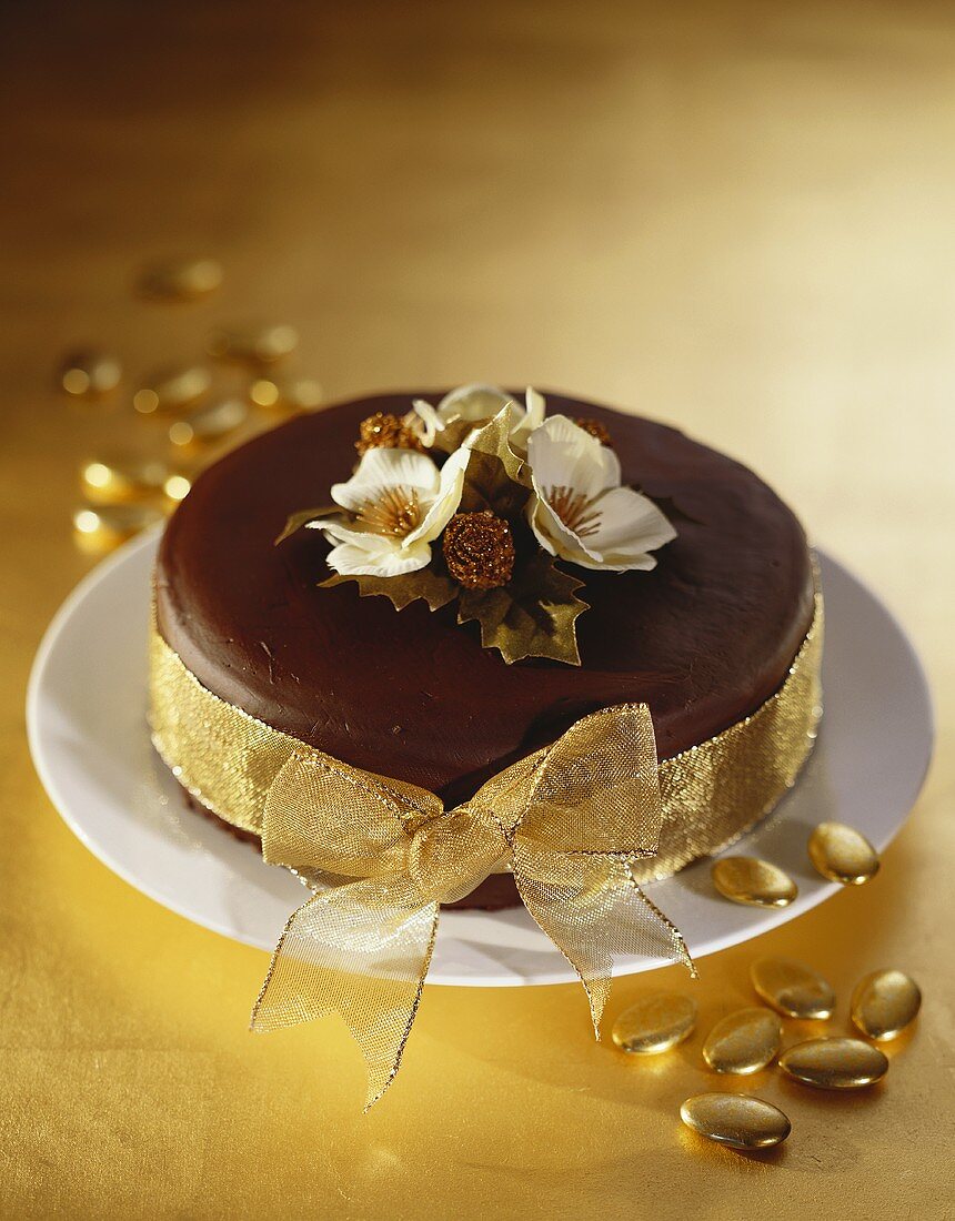 Chocolate cake with gold bow for Christmas