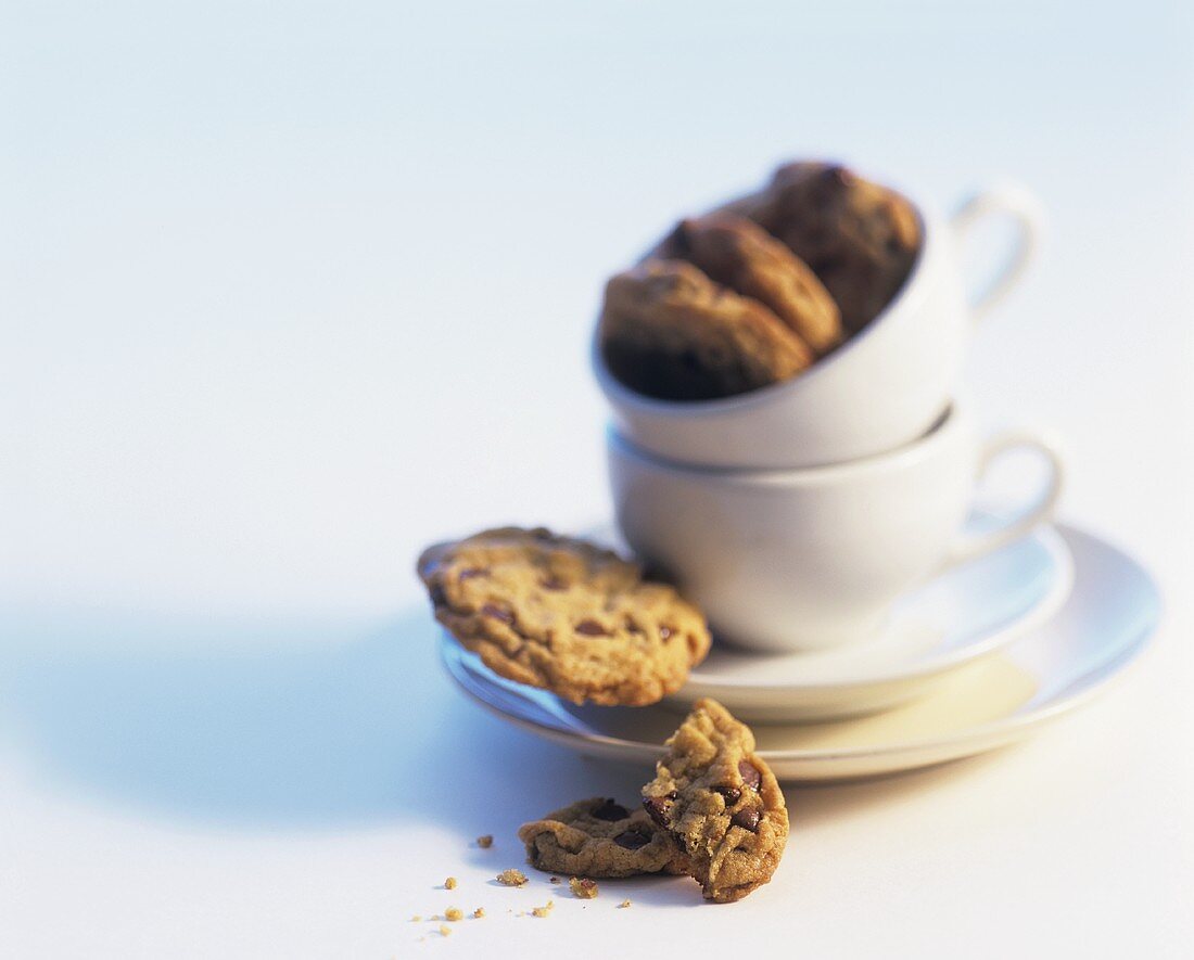 Chocolate chip cookies and coffee cups and saucers