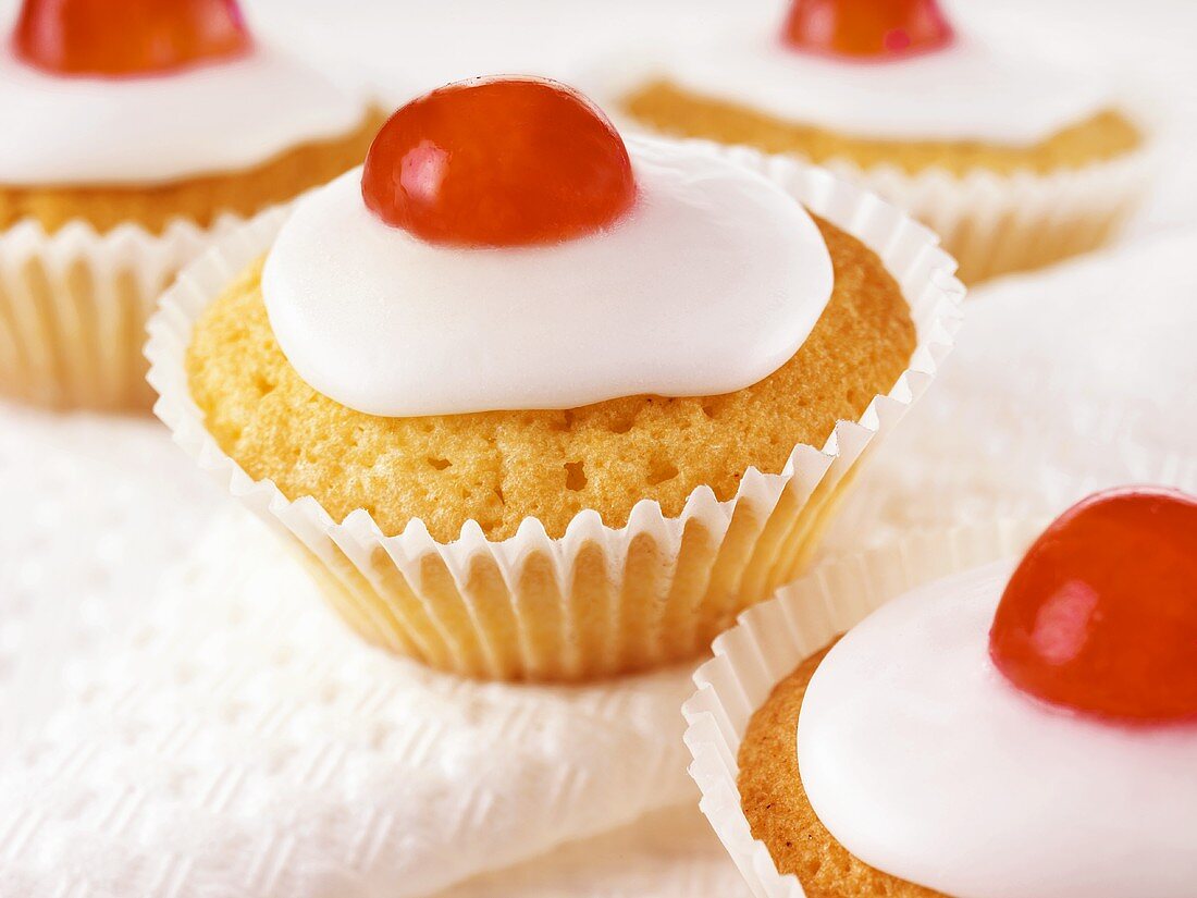 Iced cupcakes with cherries