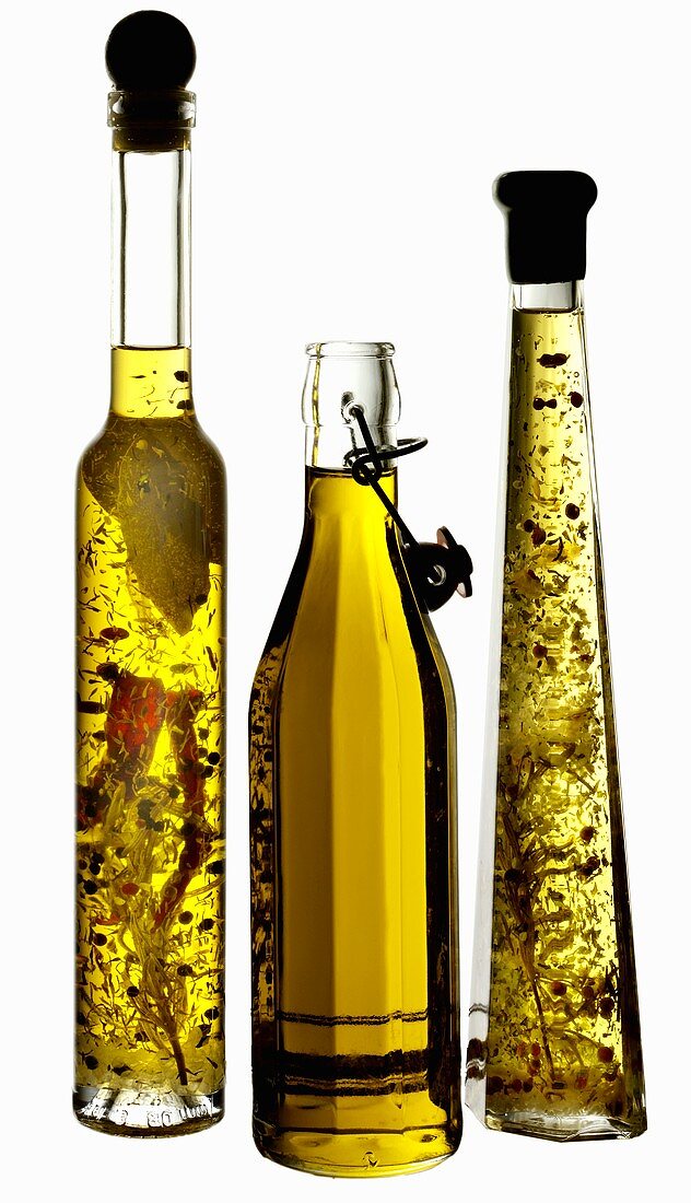 Three bottles of oil (olive oil and herb oil)