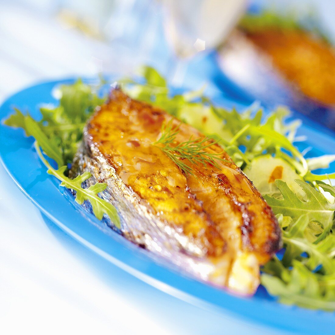 Salmon steak on rocket salad