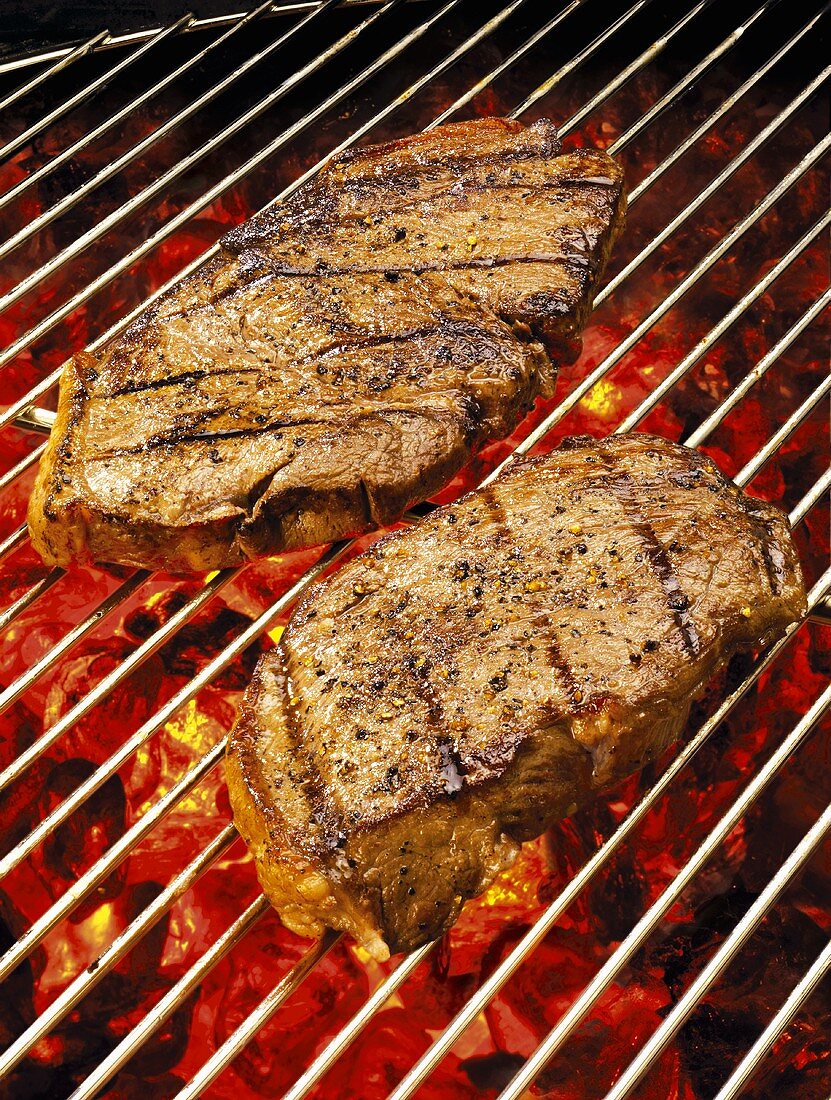 Two steaks on barbecue