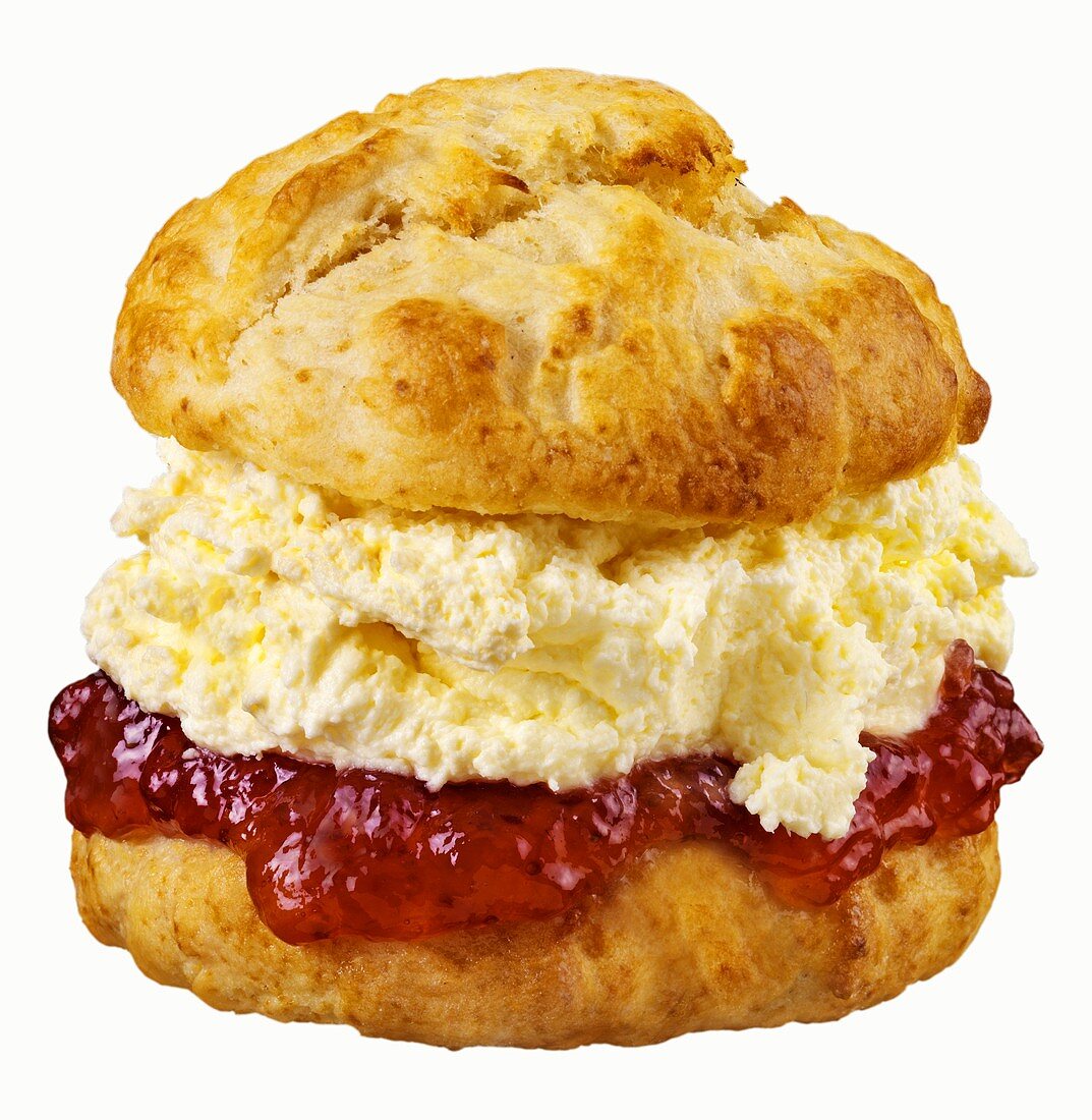 Scone with jam and cream against white background